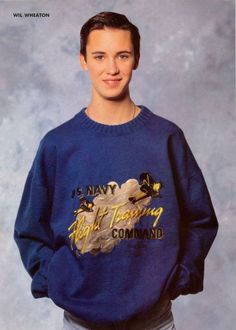 a young man wearing a navy blue sweater with the words navy, flight training command printed on it