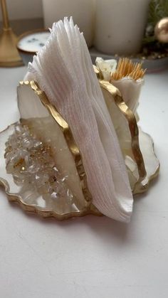 a close up of a piece of food on a table with candles in the background