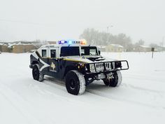 a police car is driving through the snow