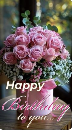 a bouquet of pink roses in a vase with the words happy birthday to you on it