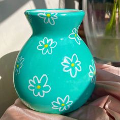 a blue vase with flowers painted on it