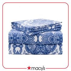 the blue and white paisley print sheet set is folded up on top of each other