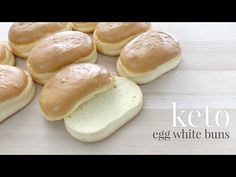 a pile of white buns sitting on top of a wooden table