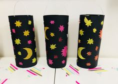 three black paper cups decorated with stars and the moon