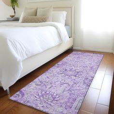 a bed with a purple rug on top of it