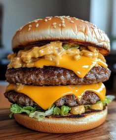 a cheeseburger with lettuce and other toppings on a wooden table