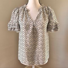 Max Studio Nwt Black And White Spotted Blouse Women’s Size Xs White With Black Allover Spotted Print V-Neckline Ruffle Short Sleeves Ruffle Trim Around Neck Casual Blouse 100% Polyester Chic Polka Dot Tops For Office, Chic Polka Dot Tops For Work, Polka Dot V-neck Top With Ruffles, Polka Dot Ruffled V-neck Top, Ruffle Shorts, Max Studio, Casual Blouse, Ruffle Trim, White And Black