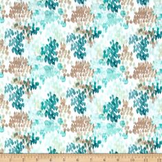 a blue and brown flower pattern on white fabric, with a ruler in the foreground