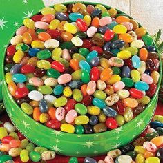 a green bowl filled with lots of candy