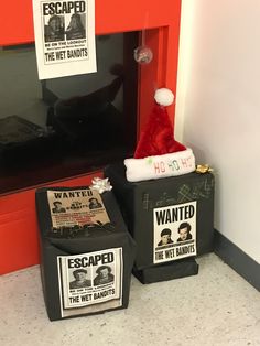 two black suitcases with santa hats on them sitting in front of a red door