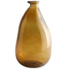 a brown glass vase sitting on top of a white table