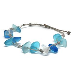 Channel your inner mermaid with this gorgeous beach bracelet or anklet made with mixed blues and white sea glass pebbles on our durable hand spun rope cord. Pure island style! Easy and secure adjustable slide knot closure allows for easy on and off. This bracelet/anklet is completely waterproof and metal free making it perfect for anyone with skin sensitivities and is a wonderful and unique gift for those hard to shop for friends and family on your list, especially the beach lovers! Color: Mixed Adjustable Blue Beach Jewelry, Adjustable Blue Jewelry For Beach, Adjustable Ocean-inspired Bracelets, Adjustable Blue Beachy Jewelry, Blue Adjustable Beachy Jewelry, Beachy Blue Adjustable Jewelry, Blue Beach Jewelry, Adjustable Ocean Color Bracelets For Beach, Adjustable Ocean Color Bracelet For Beach