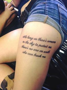 a woman with a tattoo on her thigh that reads, god long as there's someone in the sky to protect me