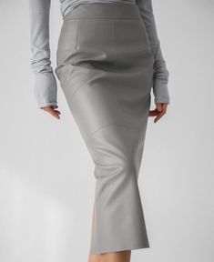 This Women's High-Waisted Split Pencil Skirt is crafted from a blend of 50% PU leather, 47% polyester, and 3% spandex, offering both a fashionable and comfortable wear. The minimalist solid color design allows for versatile pairing with any top, while the high-waisted cut accentuates your waistline. The stylish slit detail adds a touch of elegance and sophistication, making it perfect for everyday wear, office attire, or special events. The soft and form-fitting fabric ensures ease of movement a Pu Skirt, Metallic Pleated Skirt, Pencil Skirt Work, Gauze Skirts, Mid Calf Skirt, Solid Skirt, Ankle Length Skirt, Grey Pencil Skirt, Bubble Skirt