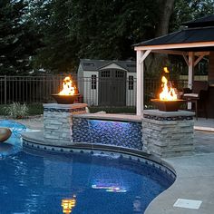 an outdoor fire pit next to a swimming pool