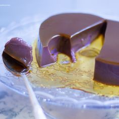 a piece of chocolate cake on a plate with a spoon