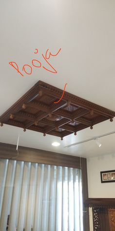 the ceiling is decorated with wood and has an orange handwritten sign above it that reads yoga