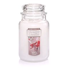 yankee candle with red flowers on the front and white jar in the back, against a white background