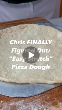 a pizza dough sitting on top of a wooden cutting board