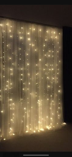 a curtain with lights on it in front of a window