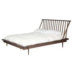 the bed frame is made from wood and has white sheets on it, as well as pillows