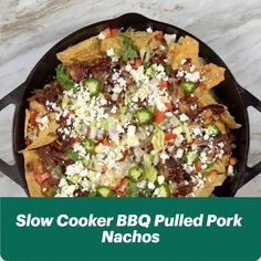 slow cooker bbq pulled pork nachos in a cast iron skillet