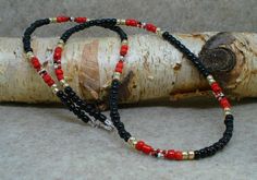 Men's Black Red Gold Sport Necklace. Black Red and Gold Beads Strung with Tiny White Red Black Gold Accent Beads on Nylon Coated Wire for Durability. 21-inch length Adjustable Red And Black Beaded Necklace, Adjustable Red Beaded Necklace With Black Beads, Bead Stringing, Necklace Black, Gold Accent, Bead Crochet, Red And Gold, Gold Beads, Gold Accents