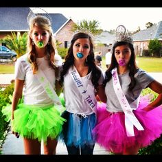 three girls in tutu skirts and crowns posing for the camera