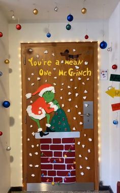 a door decorated with christmas decorations and an image of a santa clause on the front