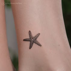 a small starfish tattoo on the foot of a woman's right leg,