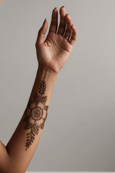 a woman's arm with a hendike on it and her hand in the air