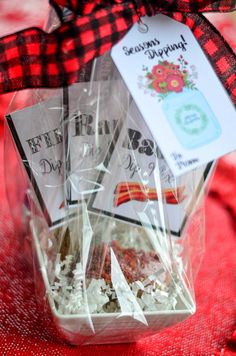 a basket filled with lots of food sitting on top of a red cloth covered table