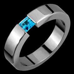 This is a 5mm  titanium & genuine blue topaz tension set ring. It is hand made on a machine. The ring is set with a 4mm genuine square blue topz. Each ring is made to the customers specifications, meaning the customer can customize the following:  -Ring size -Ring width (certain restrictions apply) -Stone size (certain restrictions apply) -Stone type (certain restrictions apply) -Metal color (black or regular titanium)  -Metal type (certain restrictions apply) -Metal finish (polished, matte, san Fingerprint Wedding, Topas Ring, Tension Ring, Titanium Rings For Men, Gems Crystals, Titanium Metal, Fashion Rings Silver, Belly Button Jewelry, Tension Setting