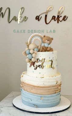 a multi layer cake with teddy bears on top