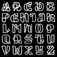 some type of alphabet written in white chalk on a black background with the letters and numbers drawn