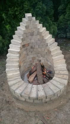 an outdoor fire pit made out of bricks