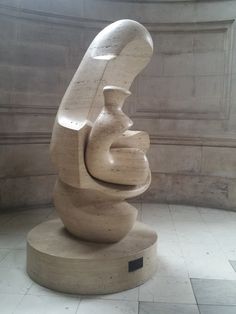 a large white sculpture sitting in the middle of a room next to a wall and floor