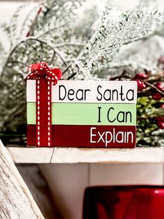 a wooden sign that says dear santa i can explain with red ribbon and bow on it