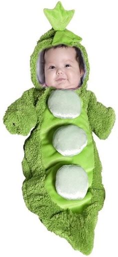 a baby in a peas costume laying on its back