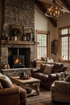 a living room filled with furniture and a fire place next to a stone wall fireplace