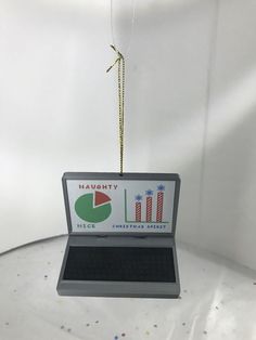 an ornament shaped like a laptop with a graph on it's screen