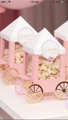 pink and white candy cart with popcorn in it