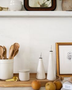 kitchen utensils are sitting on a wooden tray