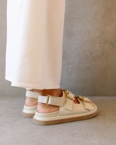 Cream Sandals With Buckle Closure And Round Toe, Cream Round Toe Sandals With Buckle Closure, Beige Double Strap Sandals With Buckle Closure, Cream Closed Toe Sandals With Buckle Closure, Modern Beige Sandals With Buckle Closure, Cream Closed Toe Sandals With Leather Footbed, Cream Sandals With Leather Footbed And Flat Heel, Cream Flat Heel Sandals With Leather Footbed, Cream Open Toe Sandals With Buckle Closure