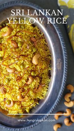 a bowl filled with yellow rice and nuts