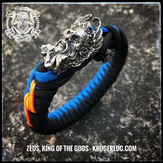 Detailed bead of Zeus, the Greek King of the Gods, ruler of heaven, with the lightning in his hands. Your choice of bead in white brass, oxidized or gold colored. Single or dual colored eccentric fishtail with lightning stitch and original bar closure. Handmade Ceremonial Blue Jewelry, Handmade Black Jewelry For Blessing, Handmade Blue Jewelry For Blessing, Adjustable Blue Oxidized Finish Jewelry, Weave Colors, Paracord Armband, Blue Orange White, Stylish Hoodies, The Lightning