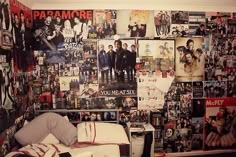 a bedroom with many posters on the wall