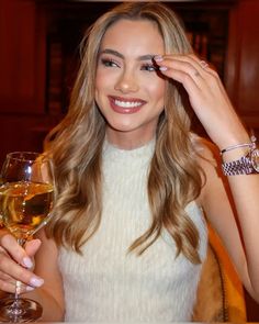 a beautiful woman holding a glass of wine