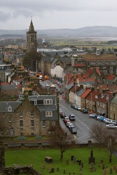 an aerial view of a city with old buildings and cars parked on the street in front of it