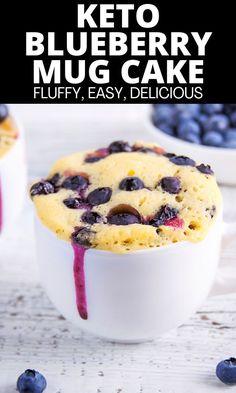 a blueberry muffin in a white bowl with berries around it and text overlay reading keto blueberry mug cake fluffy, easy, delicious